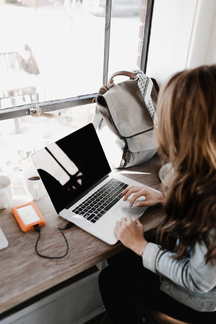 A woman sitting at her laptop on the table